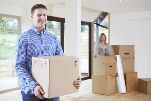 Professional movers carrying furniture through a Westminster flat