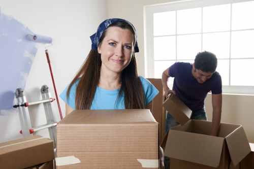 Office removals scene showing desks and equipment being prepared for transport in Westminster