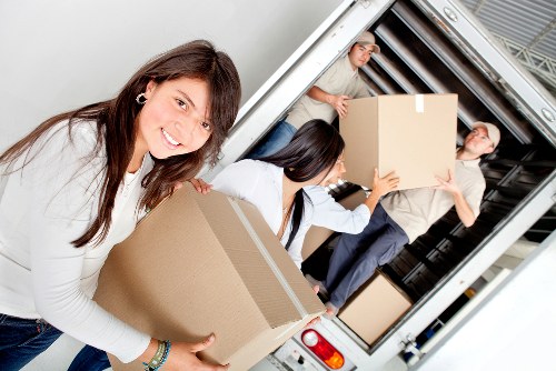 Removal company staff reinforcing safe working standards