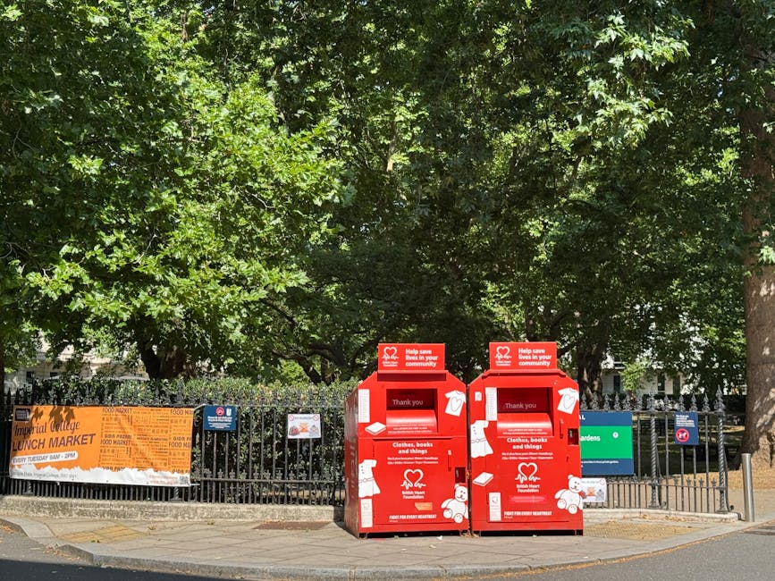 A residential street in Westminster lined with parked cars on both sides and blossoming pink cherry trees overhead, with white multi-storey buildings featuring classic architectural details on either